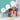 Girl in a chef hat holding the kids rolling pin while baking with a friend